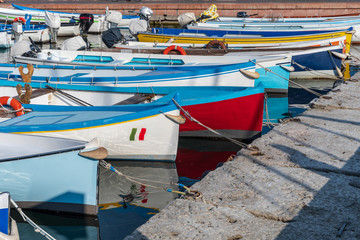 Colorful fishing boats moored at the pier, Bardolino, Italy