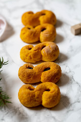 Swedish christmas. Gluten free version Traditional swedish buns in christmas setting. A saffron bun, in Swedish lussebulle or lussekatt. 