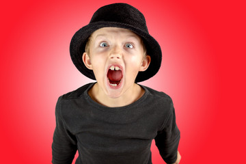 closeup of young boy heavy screaming expression with crazy look and frenzy in his eyes, very angry...