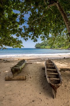 Dugout boats on the sandy beach Praia da Colonia Acoriana, Sao Tome Island, Sao Tome and Principe