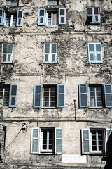 Old blue windows on stone wall