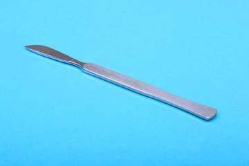 Close Up Surgical instruments and tools on blue mirror background. Selective focus.