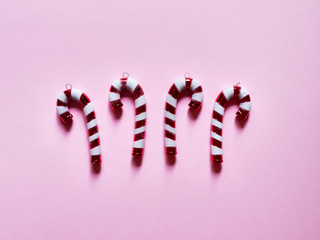 Christmas candy cane drums  at studio above view over a pink background isolated flatlay
