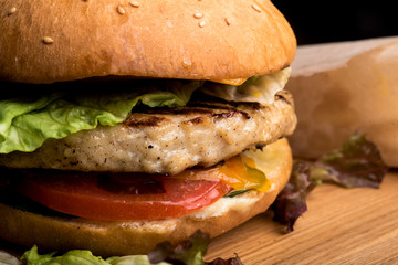 Juicy cheeseburger with lettuce, tomato, onion, and melted cheese and French fries