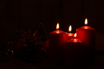 Advent mood - four red candles lighted in the darkness