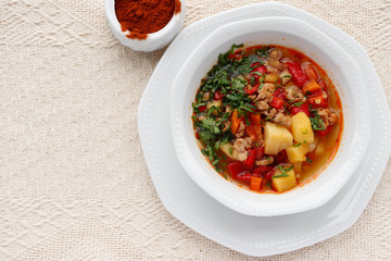 Bulgarian potato soup with paprika and minced meat.