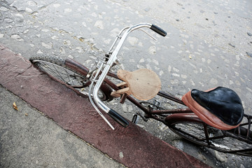 Bycicle parking on the sidewalk background grungy old street, feeling vintage