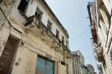 Fototapeta na wymiar HAVANA, CUBA Typical street of Havana, Cuba, with old shabby buildings and local people