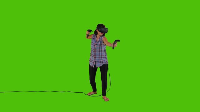 Shooting arrows using a longbow in a VR video game by a young woman over a green screen, casual look, long shot.