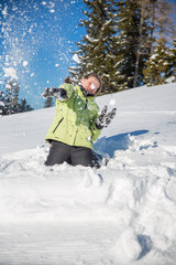 Fototapeta na wymiar Happy young woman playing with snow