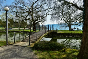  View of the arch bridge in Villette-Park on the shore of Lake Zug on a spring sunny day. Town of Cham, canton of Zug, Switzerland, Europe. © balakate