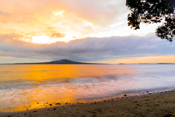 Fototapeta na wymiar Landscape Scenery during Sunrise Time at Takapuna Beach, Auckland New Zealand; View to Rangitoto Island