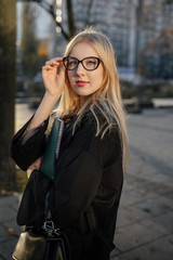 Girl stand on the park background and pose to camera