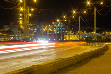 light passing cars on the bridge in Cheboksary in Russia, called the road to the temple