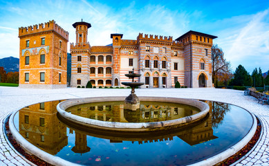 Ceconi Castle reflecting in a fountain at sunset