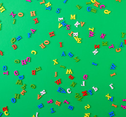 small wooden multi-colored letters of the English alphabet are scattered