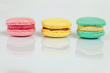 Sweet almond colorful pink, biue, yellow macaron or macaroon dessert cake isolated on white background. French sweet cookie. Minimal food bakery concept. Copy space