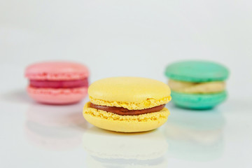 Sweet almond colorful pink, biue, yellow macaron or macaroon dessert cake isolated on white background. French sweet cookie. Minimal food bakery concept. Copy space