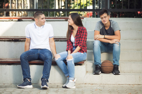 Three teenagers talking