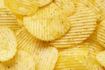 Appetizing peeled chips with paprika. Food chips background. Food Background.