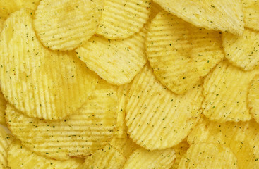 Appetizing peeled chips with paprika. Food chips background. Food Background.