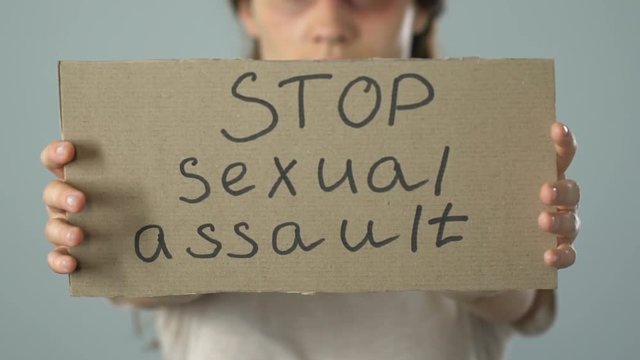 Stop sexual assault poster in bruised woman hands, problem awareness prevention