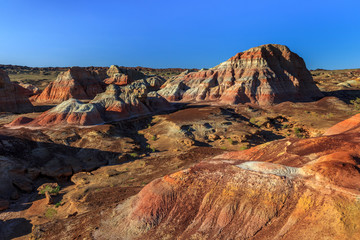 Rainbow City, Wucai Cheng. Colorful Red, Pink, Orange and Yellow landforms in a remote desert area of Fuyun County - Altay Perfecture, Xinjiang Province Uygur Autonomous Region, China. Rainbow Hills