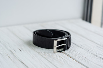 black leather belt on white background