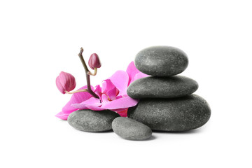 Spa stones and orchid flowers on white background