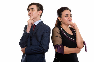 Studio shot of young Persian teenage businessman and mature Pers