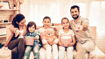 Lovely Cheerful Family Watching Movie at Home