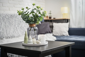 Christmas decorations with candle on coffee table