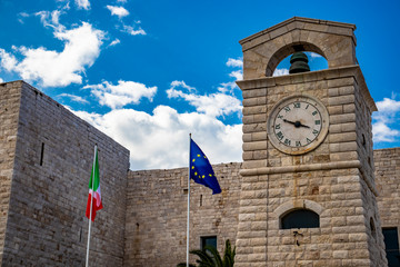 The flags of Italy and of the European community waving on the Swabian castle of Trani. Close-up of...