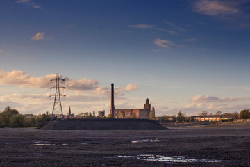Naklejka premium A industrial wasteland at sunset 