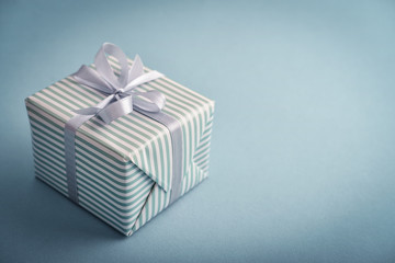 One striped  gift box with grey ribbon