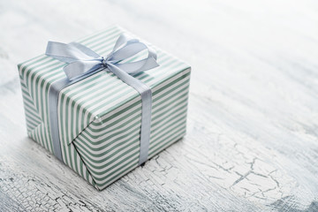 One striped  gift box with grey ribbon