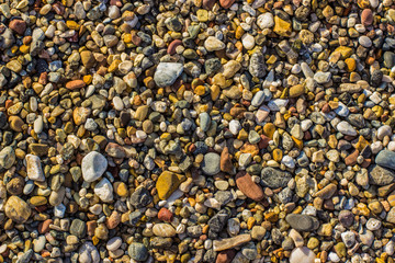 small colorful stones background texture on sea shore 