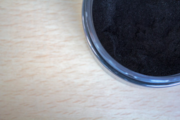 Top view of Activated charcoal powder on jar