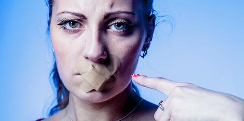 Mouth sealed shut as a symbol of pain, violence and injustice