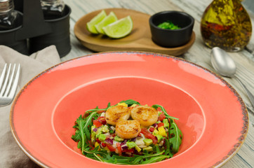 Scallop ceviche. Delicious ceviche of scallop, fish with fresh vegetables, spices and lime  