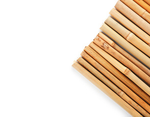 Row of bamboo sticks on white background