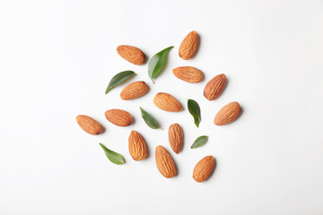Composition with organic almond nuts on white background, top view