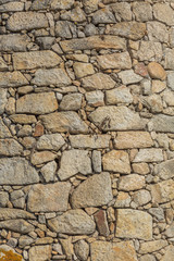 Detailed texture of masonry wall in granite stones