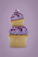 Purple blueberry cupcake on purple background, idea minimal concept for new year and christmas holliday