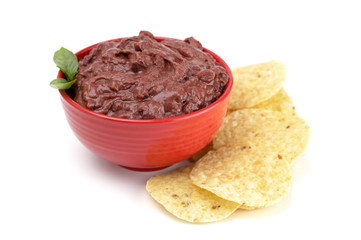 Bowl of Black Bean Dip with Chips on a White Background