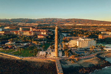Aerial lighthouse view in Meloneras area on Gran Canaria island during magical sunset.