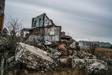 Fototapeta na wymiar Old destroyed an abandoned multi-storey building in a military t