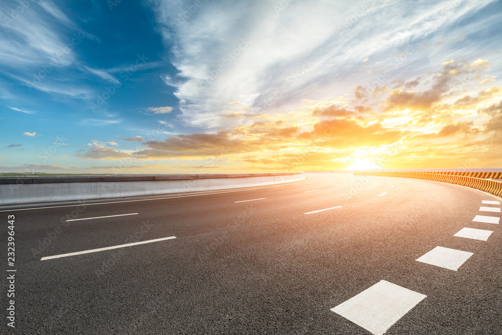 Poster Empty asphalt road and dramatic sky at sunset