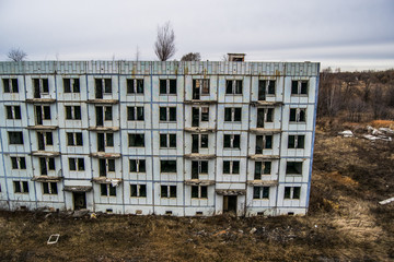 Old destroyed an abandoned multi-storey building in a military t