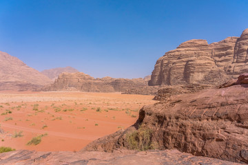 Fototapeta na wymiar Red mountains of Wadi Rum desert in Jordan. Wadi Rum also known as The Valley of the Moon is a valley cut into the sandstone and granite rock in southern Jordan to the east of Aqaba